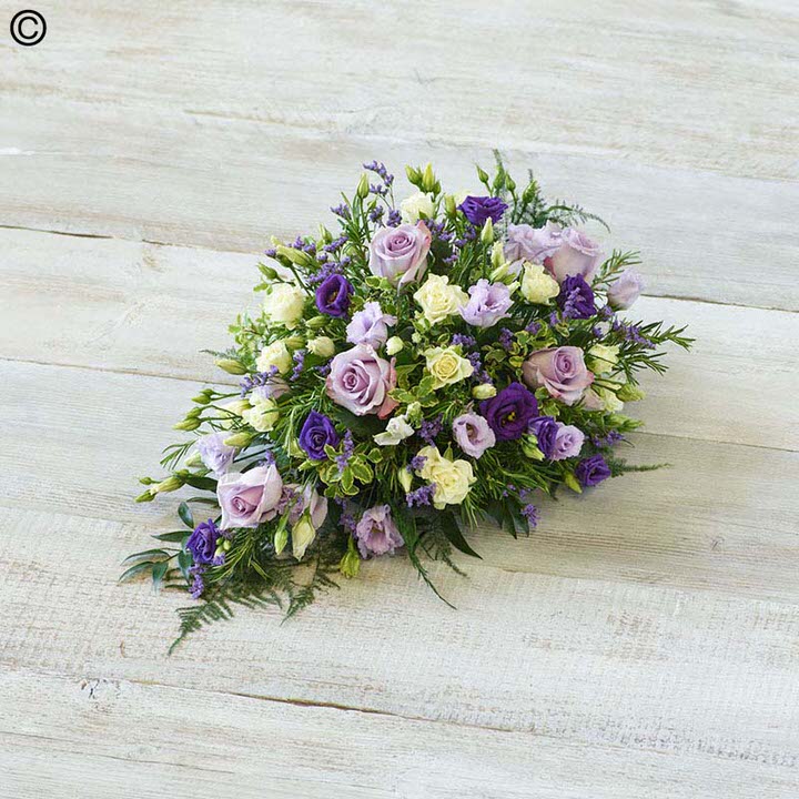 <h2>Blue Children's Casket Spray | Funeral Flowers</h2>
<ul>
<li>Approximate Size 70cm x 30cm</li>
<li>Hand created classic blue and lilac casket spray in fresh flowers</li>
<li>To give you the best we may occasionally need to make substitutes</li>
<li>Funeral Flowers will be delivered at least 2 hours before the funeral</li>
<li>For delivery area coverage see below</li>
</ul>
<br>
<h2>Liverpool Flower Delivery</h2>
<p>We have a wide selection of casket flowers offered for Liverpool Flower Delivery. Casket flowers can be provided for you in Liverpool, Merseyside and we can organize Funeral flower deliveries for you nationwide. Funeral Flowers can be delivered to the Funeral directors or a house address. They can not be delivered to the crematorium or the church.</p>
<br>
<h2>Flower Delivery Coverage</h2>
<p>Our shop delivers funeral flowers to the following Liverpool postcodes L1 L2 L3 L4 L5 L6 L7 L8 L11 L12 L13 L14 L15 L16 L17 L18 L19 L24 L25 L26 L27 L36 L70 If your order is for an area outside of these we can organise delivery for you through our network of florists. We will ask them to make as close as possible to the image but because of the difference in stock and sundry items it may not be exact.</p>
<br>
<h2>Liverpool Funeral Flowers | Casket Flowers</h2>
<p>This children's casket spray has been loving handcrafted by our expert florists. This delicate casket spray arrangement includes pure white calla lilies and large-headed roses contrasted with sweetly fragrant lilac freesia, September flowers, purple lisianthus and is trimmed with seasonal foliages.</p>
<br>
<p>Funeral Casket Flowers the main tribute and are sometimes, depending on the family's wishes, the only flower arrangement. They are usually chosen by the immediate family.</p>
<br>
<p>Casket sprays are placed directly on top of the coffin. The sprays are large diamond shape tributes. The flowers are arranged in floral foam, which means the flowers have a water source meaning they look their very best for the day.</p>
<br>
<p>Containing 3 white roses, 5 white calla lilies, 4 lilac freesia, 3 purple lisianthus, 2 lilac September flower and seasonal mixed foliage.</p>
<br>
<h2>Best Florist in Liverpool</h2>
<p>Trust Award-winning Liverpool Florist, Booker Flowers and Gifts, to deliver funeral flowers fitting for the occasion delivered in Liverpool, Merseyside and beyond. Our funeral flowers are handcrafted by our team of professional fully qualified who not only lovingly hand make our designs but hand-deliver them, ensuring all our customers are delighted with their flowers. Booker Flowers and Gifts your local Liverpool Flower shop.</p>
<br>
<p><em>Janice Crane - 5 Star Review on Google - Funeral Florist Liverpool</em></p>
<br>
<p><em>I recently had to order a floral tribute for my sister in laws funeral and the Booker Flowers team created a beautifully stunning arrangement. Thank you all so much, Janice Crane.</em></p>